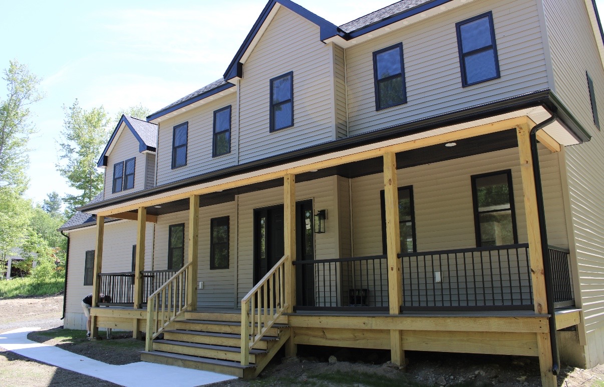 Full-length covered front porch with natural cedar posts
