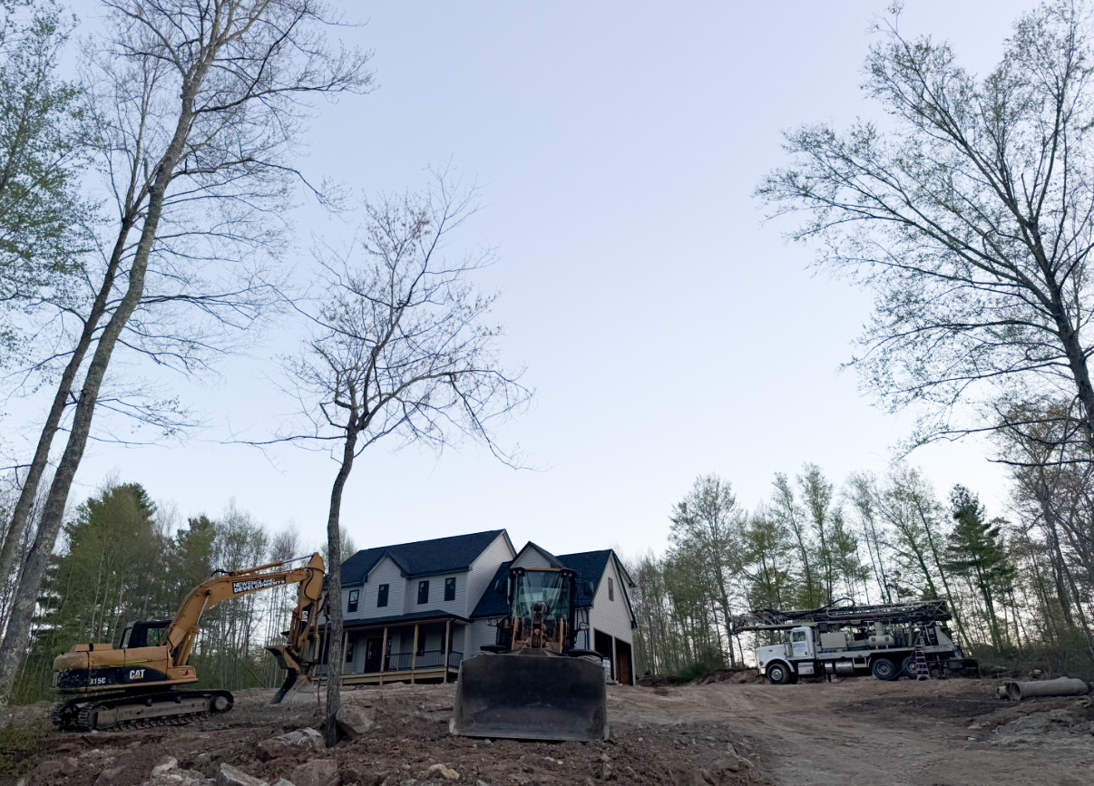 Brook Road Estates construction site with excavator and well rig